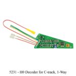 A model train HO decoder circuit board with wires on a gradient background.