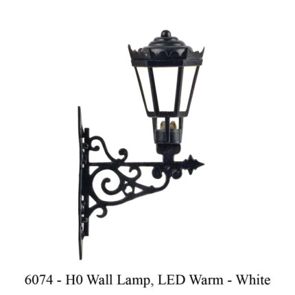 Train Model Black metal wall-mounted lamp with ornate bracket and frosted white LED light. Train Model & Railway Accessories available @ The TrainYard in Paarl